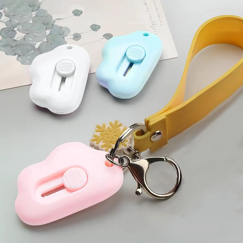 9 Pack Retractable Box Cutter Set With Mini Letter Opener And Cute Cloud Charm, shown with keychain attachment