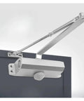 Close-up of dual spring automatic door closer with hydraulic buffer for ultra quiet no slams smooth close adjustable speed gear.