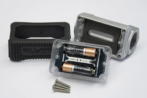 Disassembled parts of Inline 1 Inch Digital Turbine Meter for Chemical Transfers, batteries, nickel plated housing, and screws