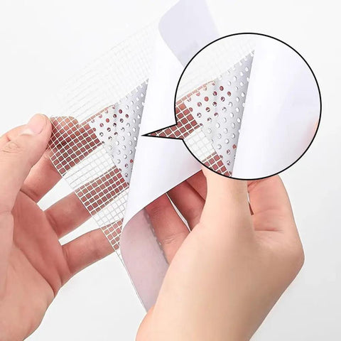 Hands holding a Heavy Duty Drywall Repair Kit With 6 Self Adhesive Patches 4 By 4 Inch Aluminum And Fiberglass Mesh Patches