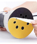 Dope 5 Inch Yellow Sanding Discs With 8 Holes For Fast Debris Removal shown on a disc sander being attached.