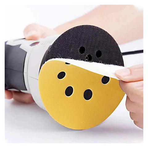 Dope 5 Inch Yellow Sanding Discs With 8 Holes For Fast Debris Removal shown on a disc sander being attached.