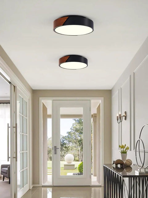 Sleek Modern Black Flush Mount Ceiling Light With 2 Lights, Mid Century Round Wood Accent Fixture in a hallway.