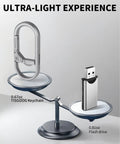 Rugged Titanium Carabiner Keychain Clip With Quick Release Minimalist EDC Key Hook And Bottle Opener next to a USB drive