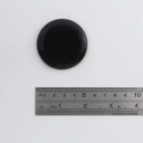 Heavy Duty Self Stick Furniture Sliders Round Two Inch Pads For Hardwood Floors No Sweat Setup Moves Large Couches And Tables With Ease Glides Like Butter Today, black round slider with ruler for size reference.