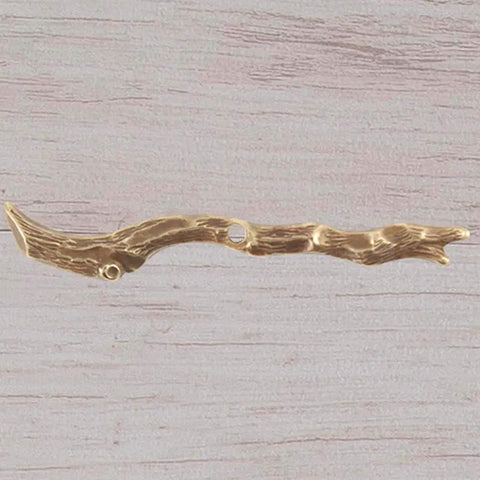 Metallic twig pendant on wooden surface, ideal for crafts and jewelry making.
