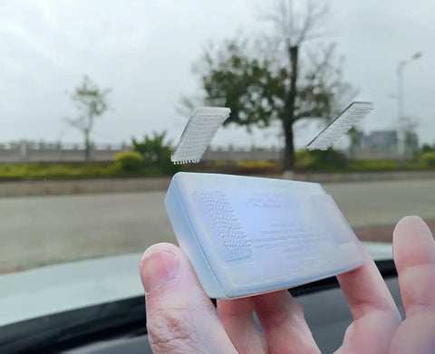 Rock Solid Transponder Mounting Strips For Windshield Toll Tags Heavy Duty Dual Lock Tape shown holding on glass.