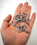 Hand holding multiple 316 Stainless Steel D Shackle Mini Shackles For Paracord Jewelry And Bracelet Hardware Built Tough Marine Grade Rigging 1 Eighth Inch Pin Opening Durable Pack Of 10 For Survival Gear And Craft Projects.