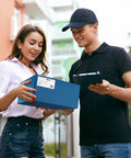 Woman receiving a package from a delivery person, representing navy blue poly mailers 12x15.5 inch 100 pack self sealing shipping bags.