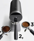 Automatic 58mm Electric Coffee Tamper With Height Adjustable Stand and Rock Solid Precision Press for Smooth Espresso Pulls demonstrating coffee grounds.