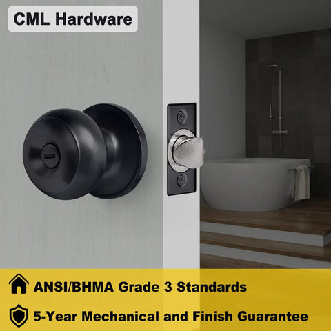 Close-up of matte black round ball handle door knob with privacy lock installed on a bathroom door, showing adjustable latch.