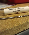 Straight Up The Badass 0785 Inch Number 47 Carbide Screw Machine Length Drill shown with protective tube on wooden surface.