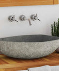 HKPWRBFG River Stone Sink Oval Wash Basin Bathroom Countertop Vessel on wood vanity with modern faucets and plants