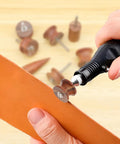Hand using Seven Piece Pro Grade Leather Burnishing Tools Set with Red Sandalwood Edge Polishing Bits for rotary tools