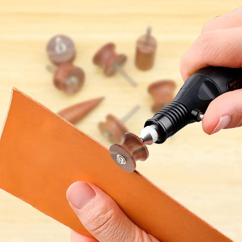 Hand using Seven Piece Pro Grade Leather Burnishing Tools Set with Red Sandalwood Edge Polishing Bits for rotary tools