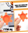 Plum-shaped rubber coupling pad for jaw couplings held in hand, orange color, pro-grade flexible shock absorbing cushion.