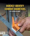 Close-up of 935CSEL Magnetic Combo Square Ruler For Electricians And Carpenters measuring conduit diameter with ruler and level tool.