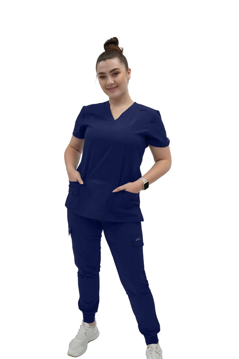 Women's V Neck Scrub Top Delivering Killer Comfort And Sharp Navy Styling Crafted For Nurses Wanting Fresh Medical Uniform Looks. Model wearing navy scrub top with pockets.