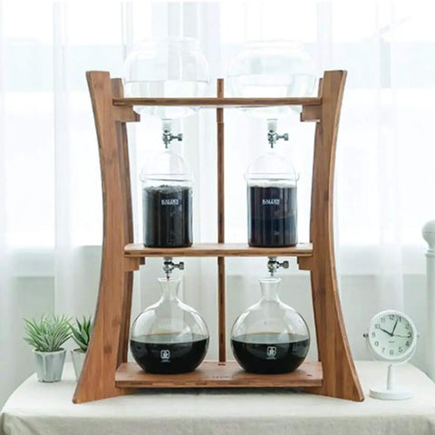 Heavy Duty Dutch Cold Brew Coffee Maker With Solid Wood Tower And Stainless Steel Filter brewing iced coffee with glass vessels.