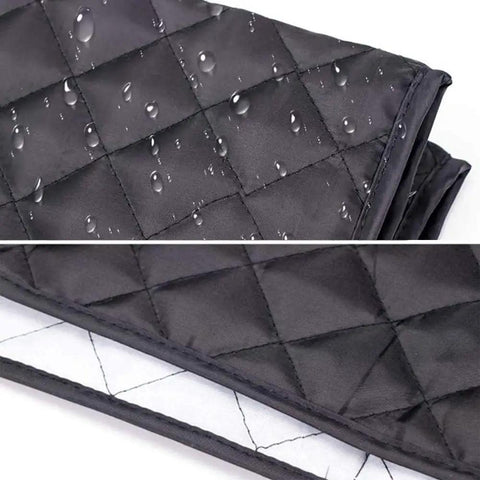 Close-up of waterproof coffee maker cover for Keurig single serve brewers, quilted black fabric with water droplets.
