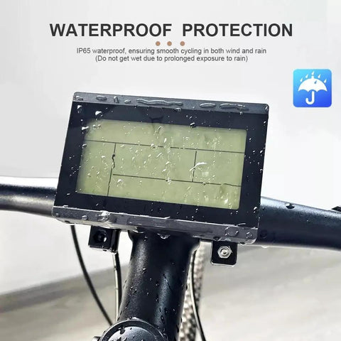 LCD Display Meter KT LCD3U All In One With USB Interface And Waterproof Plug mounted on handlebar, rain droplets visible