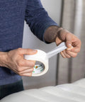 Person using Heavy Duty White Duct Tape 3 Pack 1.88 Inch By 30 Yard Rolls for repair on vinyl surface, showing strong adhesion.