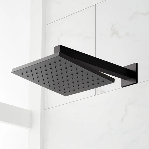 Slick Matte Black Hibiscus Thermostatic Shower System With 1.8 GPM Flow Control overhead shower head viewed against white tiles.