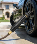 Beast Mode High Pressure Water Gun Nozzle with 360 Degree Rotating Jet Spray for car wash beside a black car tire
