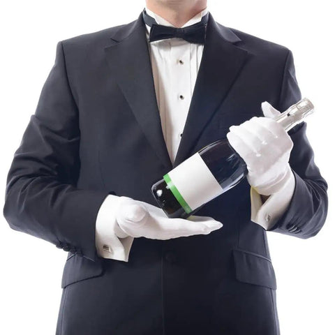 Person in tuxedo holding a wine bottle wearing White Cotton Gloves 10 Pairs Large Size Handy For Art Handling Crafting Jewelry And Silver Inspection Washable Reusable Archival Gloves For Cleaning And Display Perfect For Coin Grading And Delicate Tasks.