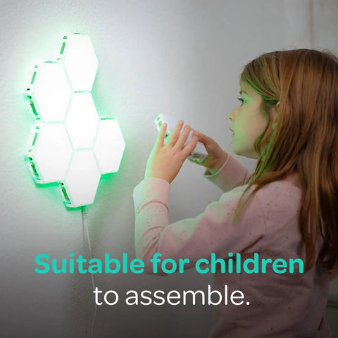 Child interacting with 7 Piece Tap Tap Sensory Lights Kit With Touch And Remote Control Multicolor Magnetic Hexagon Tiles on wall.