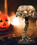 Light Up Skeleton Table Lamp With Four Bone Skull Design in front of pumpkin and candles, spooky Halloween decor