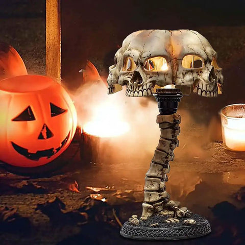Light Up Skeleton Table Lamp With Four Bone Skull Design in front of pumpkin and candles, spooky Halloween decor