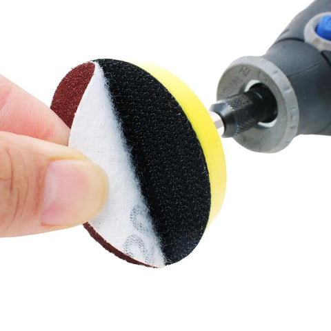 100 Pack 2 Inch Sanding Discs Kit With Polishing Pad Plate held near a drill
