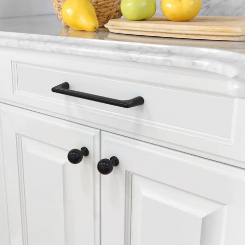 Sleek Matte Black Cabinet Pulls 10 Pack Five Inch Drawer Handles on white kitchen cabinets with fruits on counter.