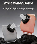 Handsfree Wrist Water Bottle For Outdoor Sports On The Go Hydration Gear in orange and gray on rocky surface
