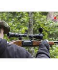 Hunter aiming with Red Dot Laser Bore Sight For Shotgun In-Chamber Cartridge With Two Battery Sets, visible red laser dot.
