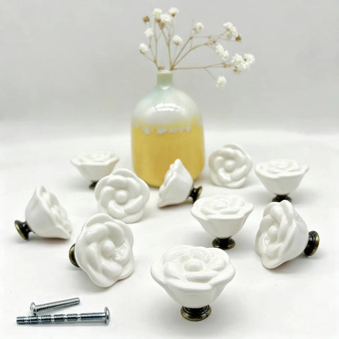 Porcelain Flower Knobs Set Of 10 White Rose Cabinet Pulls with M4 screws, displayed in front of decorative vase.