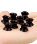 Black Silicone Ear Gauges Tunnels Plugs 00G 10mm Ultra Thin Flexible Dope Set Of 4 Pairs displayed on hand