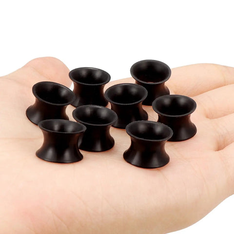 Black Silicone Ear Gauges Tunnels Plugs 00G 10mm Ultra Thin Flexible Dope Set Of 4 Pairs displayed on hand