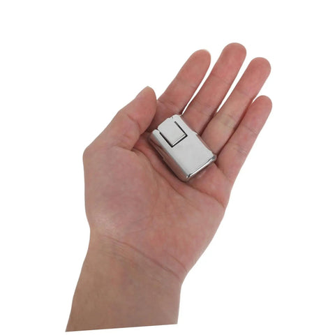 Hand holding a single silver clasp from 8 Pack Silver Metal Box Clasps With Spring Loaded Center Latches Lockable Draw Latch Hardware