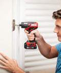 Man using 12V Cordless Drill Driver And One Quarter Inch Hex Impact Combo Kit With Two 2.0Ah PW Core 12 Batteries And Charger on door hinge
