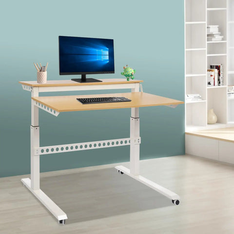 Heavy Duty Dual Tier Standing Desk With Smooth Crank Lift Tough Locking Wheels And Roomy Carbon Steel Desktop For Home Office side view in modern workspace.