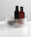 Two Pack Fluted Lazy Susan Plastic Spinner Turntable For Kitchen Counter Organizing Rotating Organizer Swivel Tray For Spices And Accessories 9 Inch Round Clear Sturdy Build with bottles inside.