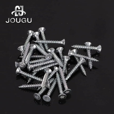 Top Shelf Carbon Steel Wood Screws Number Six By One Inch Flat Countersunk Heads With T10 Torx Star Drive Self Tapping Galvanized Deck Fasteners 200 Pack tough screws scattered on a black surface.