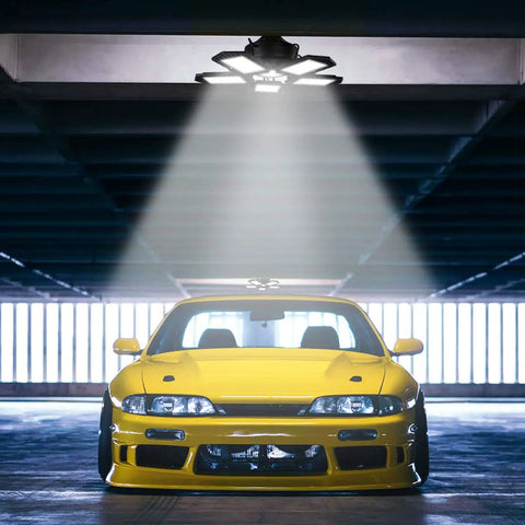 Ultra Bright 150W LED Garage Light With Five Adjustable Panels 6500K Daylight 15000 Lumens lighting parked yellow car