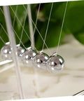 Close-up of Newton Pendulum Desk Toy For Home Office Decor Square Iron Balance Gadget That Makes Physics Fun Hands On Learning Tool