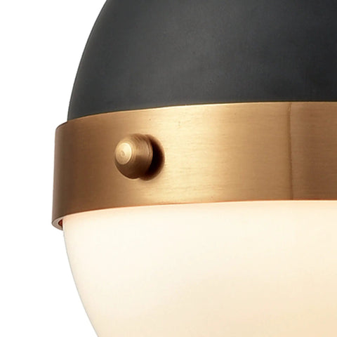 Close-up of Harmelin Mini Pendant Light in matte black with frosted glass globe and brass detail, modern design.