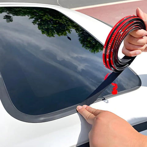 Person applying beefy EPDM rubber door weatherstrip to a GMC Hummer EV window for tight sealing performance.