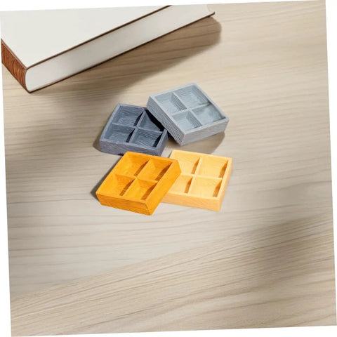 Four Grid Miniature Resin Storage Box Set For Dollhouses And Fairy Gardens on wooden surface