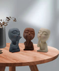 Three silicone girl head planter molds for succulents on a wooden table, part of Two Piece Girl Head Planter Molds For Pots Made From Concrete And Silicone Face Portrait Sculpture Planter For Succulents Indoor Outdoor Home Garden Decor Balcony Patio Yard.